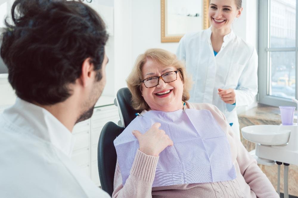 same-day crowns dedham | woman at dentist