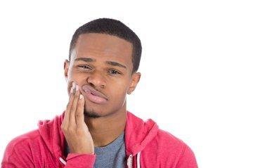 man with dental emergency in Dedham MA