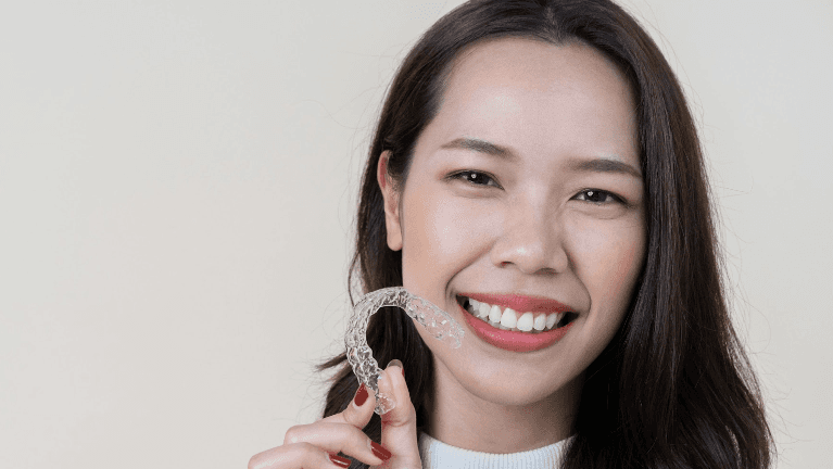 woman smiling with clear aligners | invisalign norwood