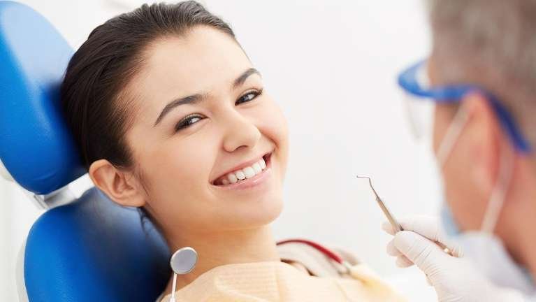 dedham dentist | Woman at dentist
