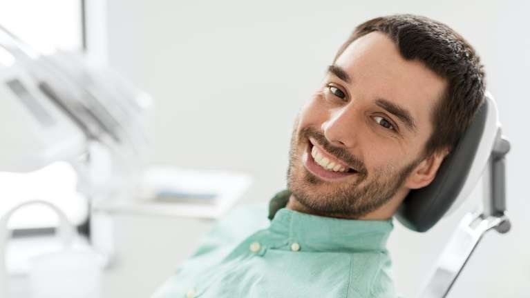 preventive dentistry dedham | man at dentist