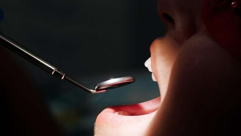 emergency dentist dedham | Woman receiving an oral exam