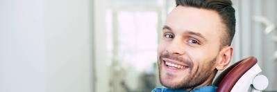 emergency dentist dedham | Man smiling in dentist's chair